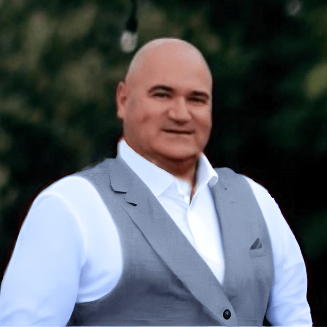 Man with white shirt and grey vest